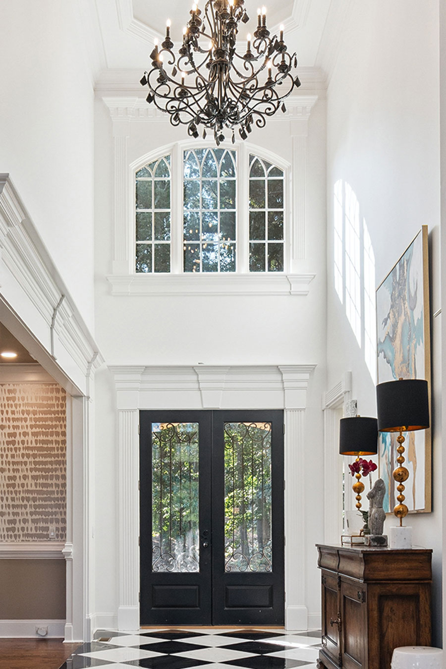 Bright and inviting kitchen in Acworth, Georgia featuring sleek white cabinets, elegant granite countertops, and modern stainless steel appliances, complete with a stylish breakfast bar and comfortable bar stools for casual dining.